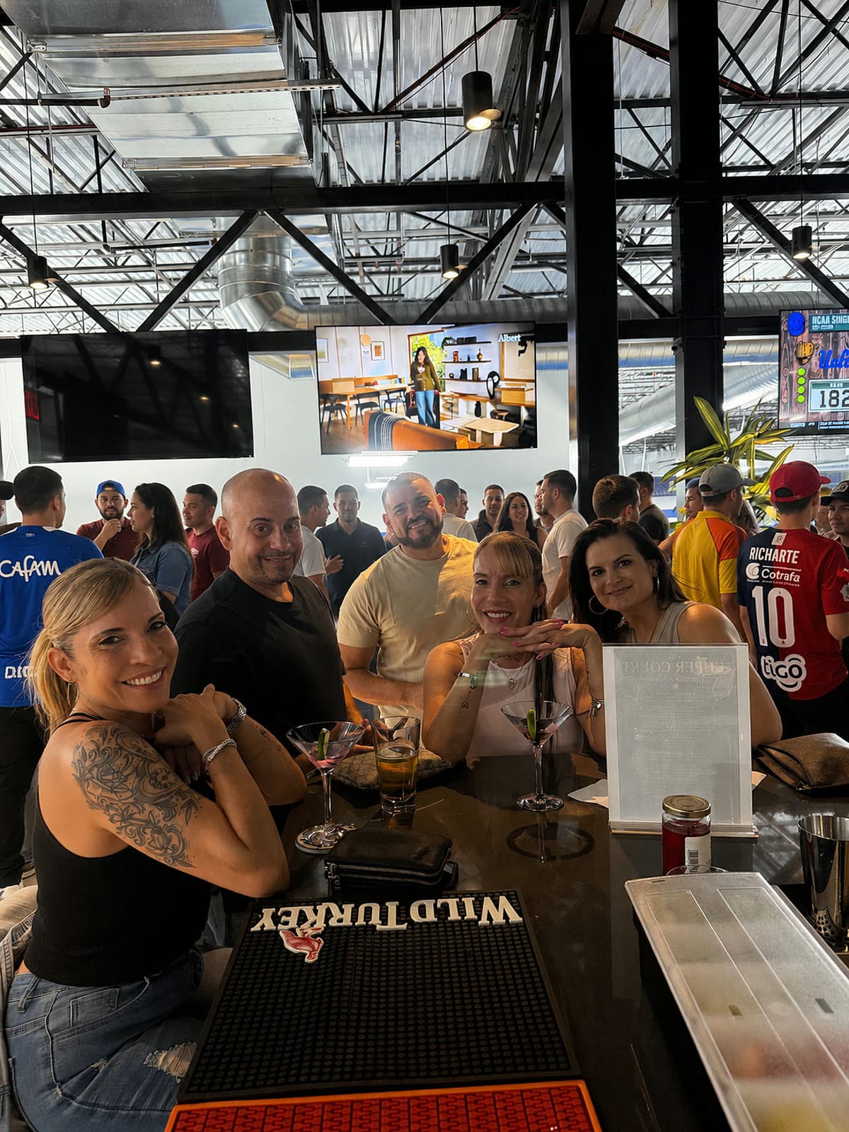 Corporate guests gathered at the bar inside The Upper Court