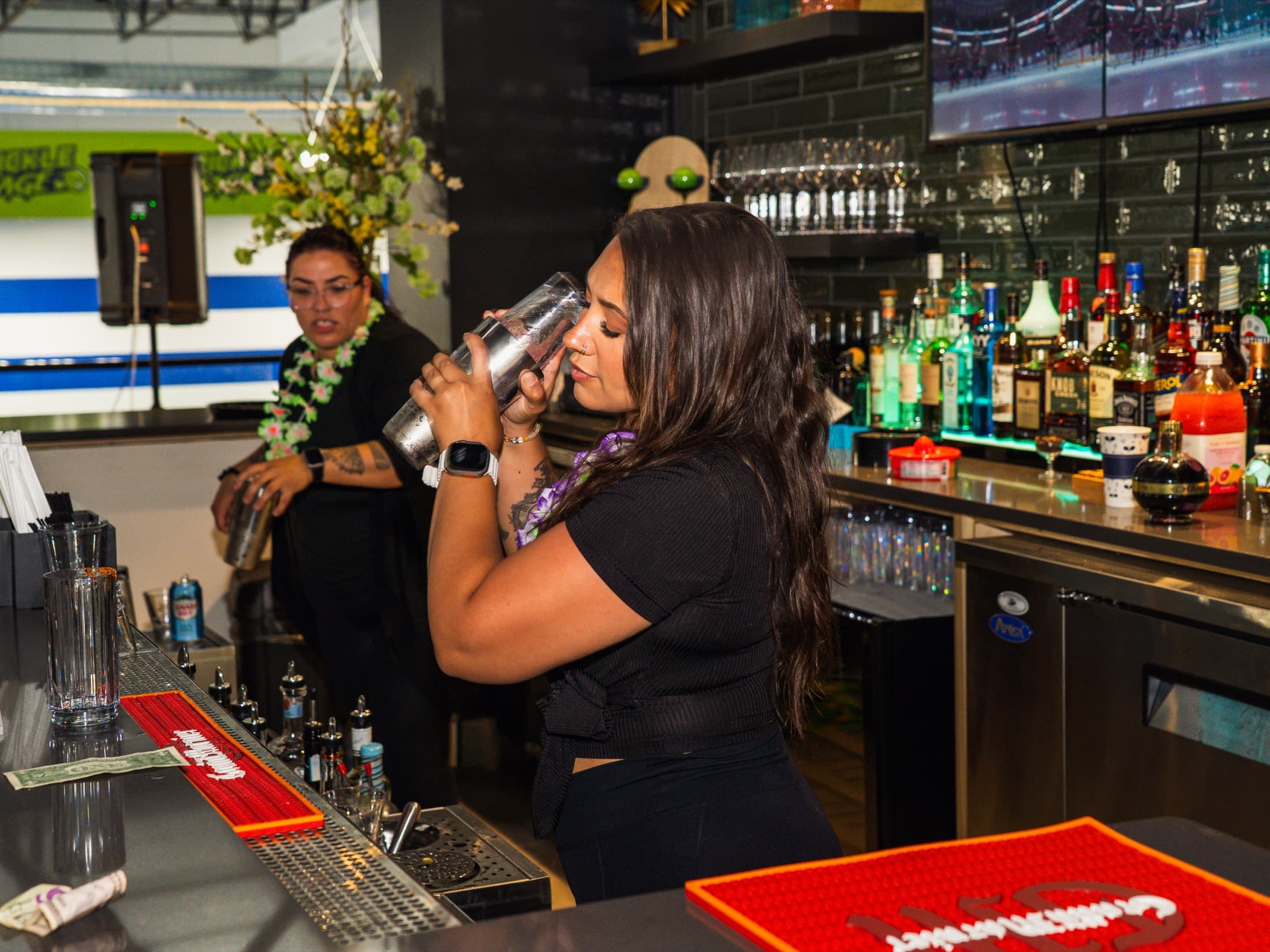 Bartender preparing a drink at The Upper Court bar