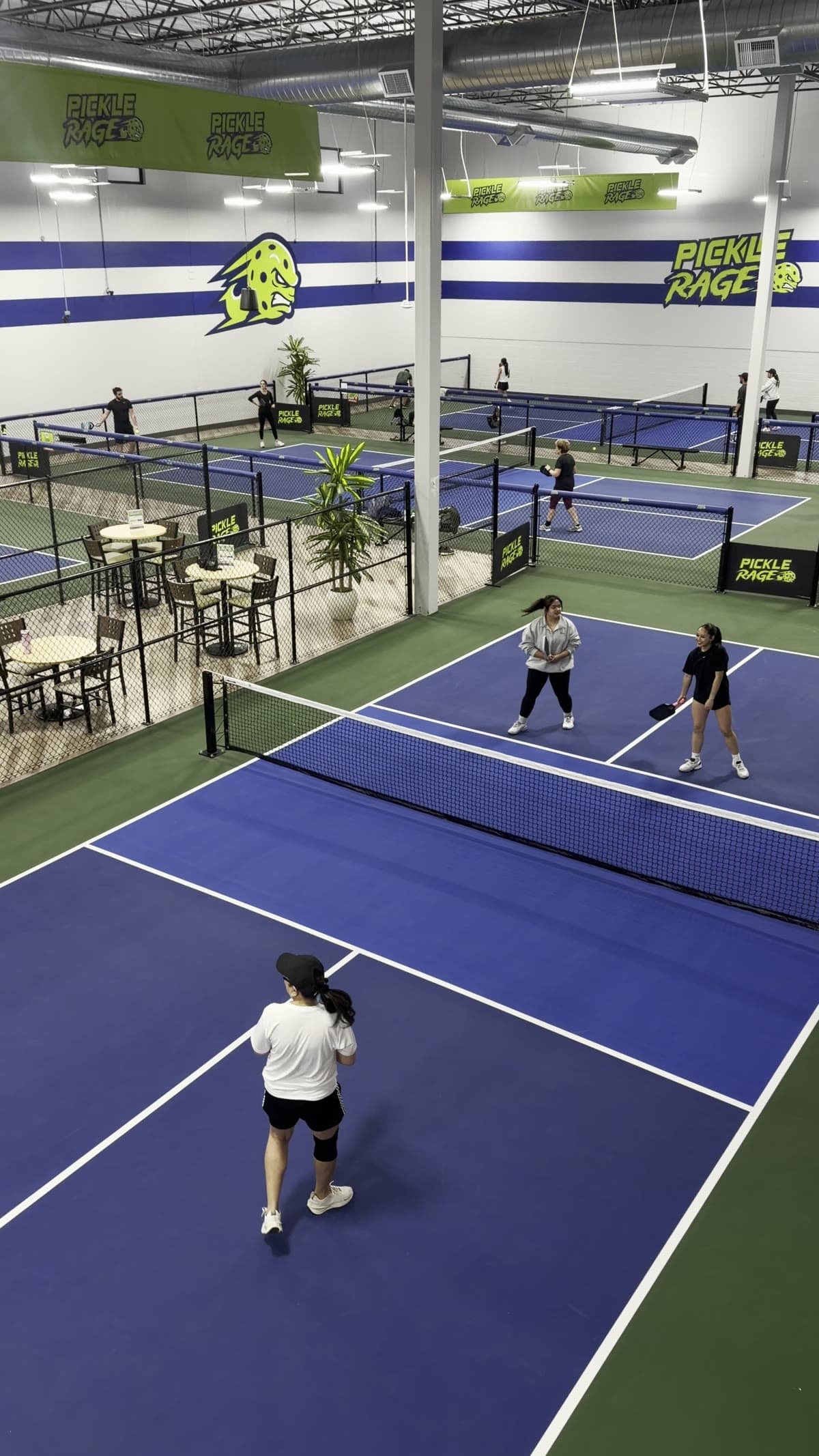 Guests playing pickleball on the indoor courts